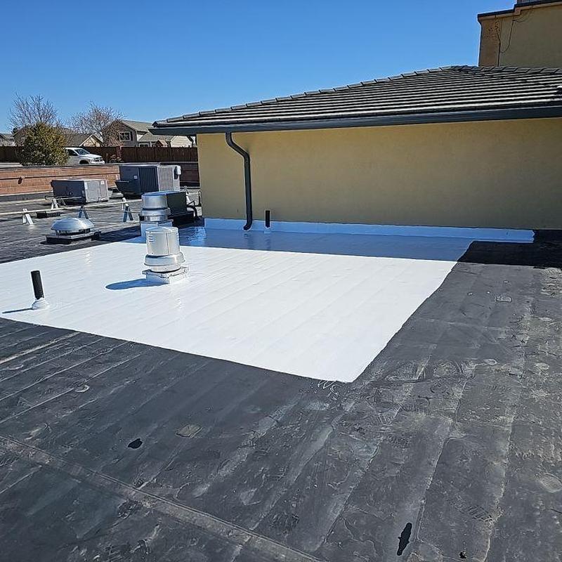 EPDM flat roof patch with white Gaco coating EPDM flat roof patch with white Gaco coating