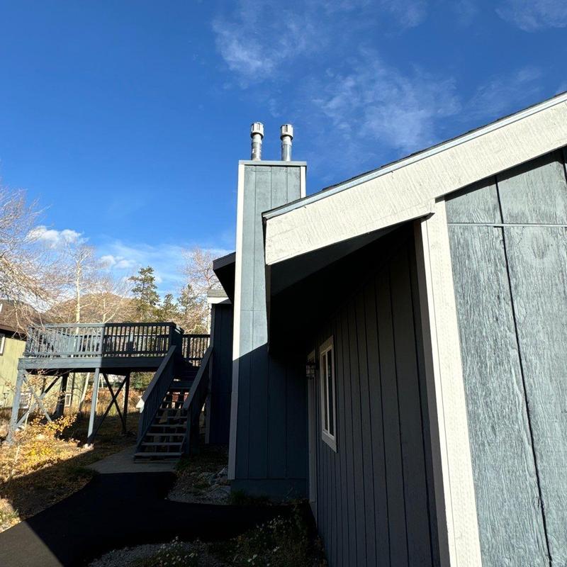 Asphalt shingle roof with chimney and deck stairs Asphalt shingle roof with chimney and deck stairs