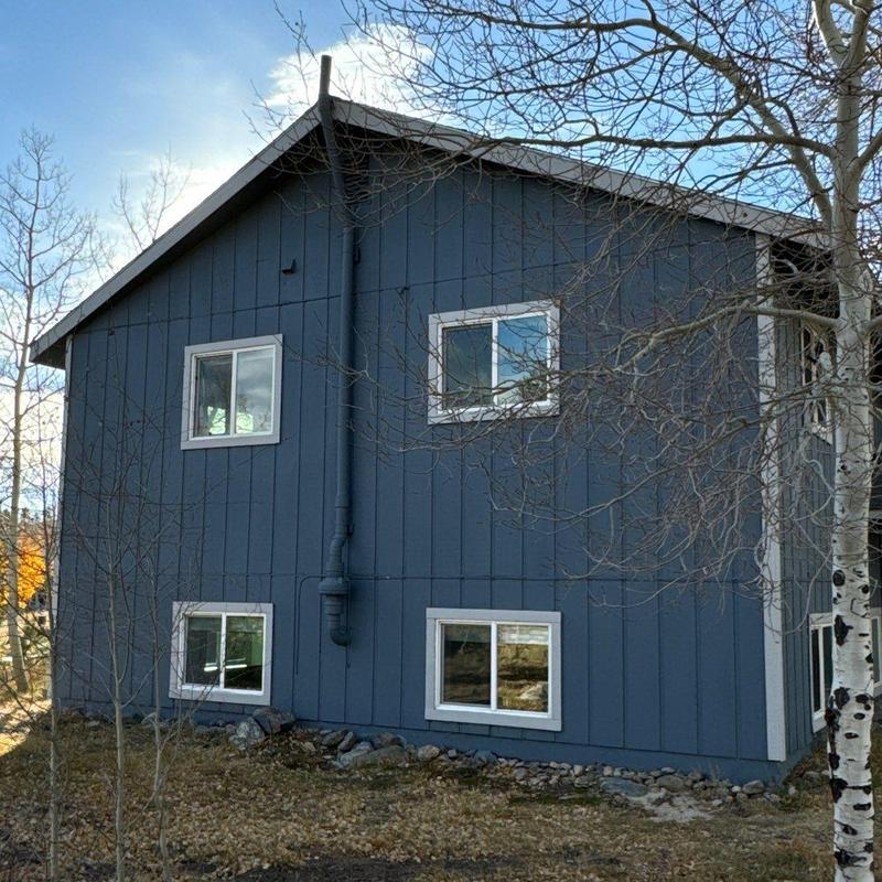 Asphalt shingle roof with blue siding and white windows Asphalt shingle roof with blue siding and white windows