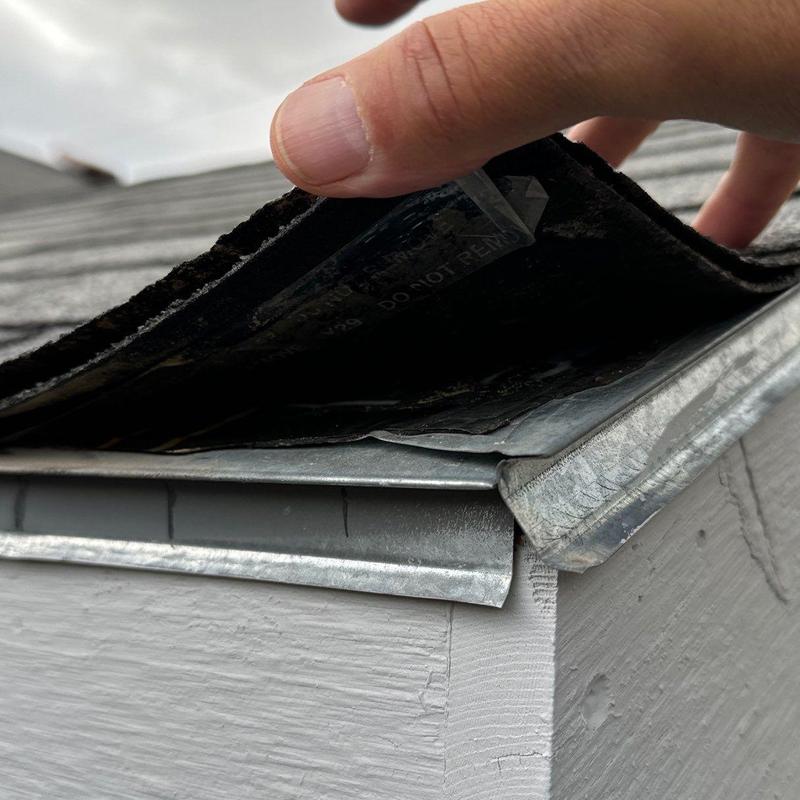 Asphalt shingle roof edge inspection showing underlayment and flashing Asphalt shingle roof edge inspection showing underlayment and flashing