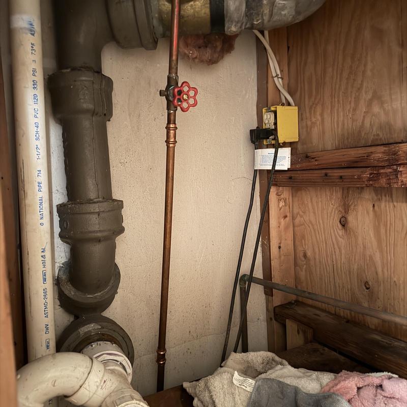 Main copper water line with shutoff valve in utility room