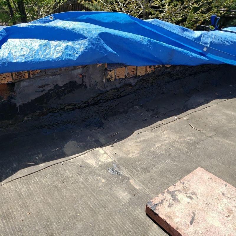 Flat roof flashing with tarp covering damage Flat roof flashing with tarp covering damage