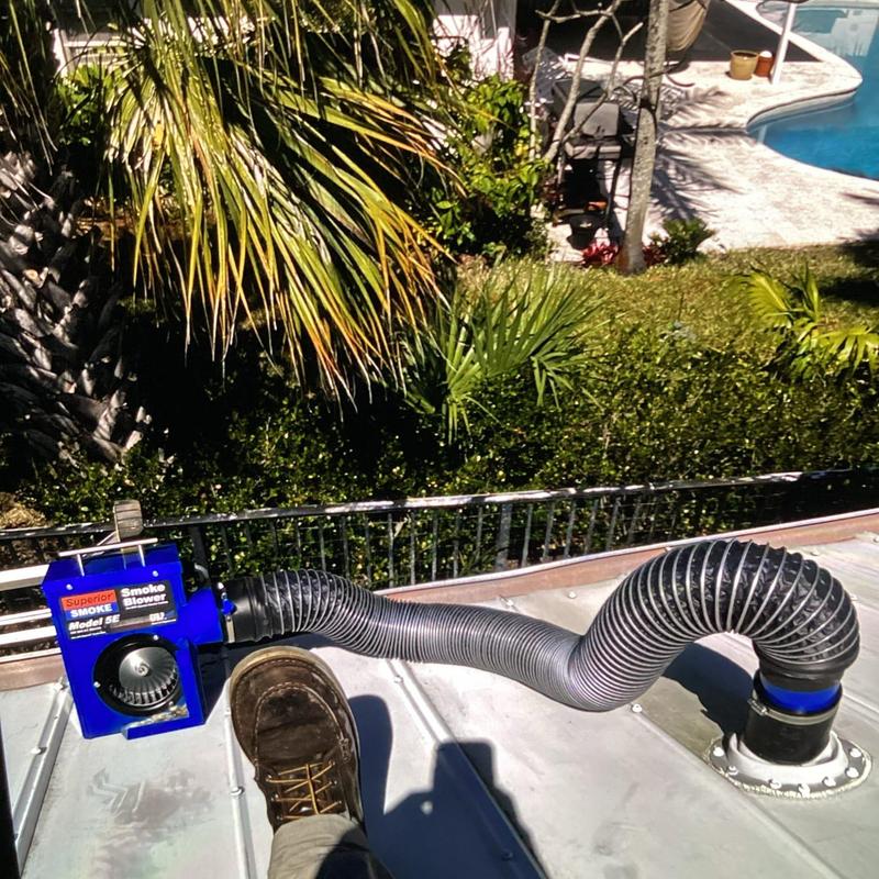 Smoke blower testing roof vent with flexible ducting