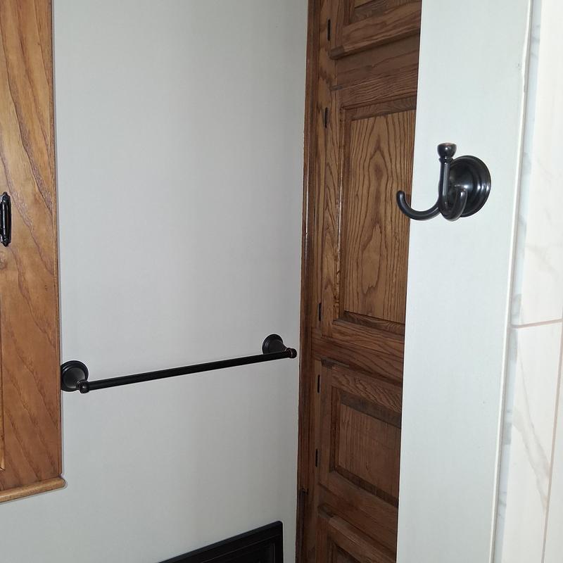 Bathroom towel rod and hooks installation on wall