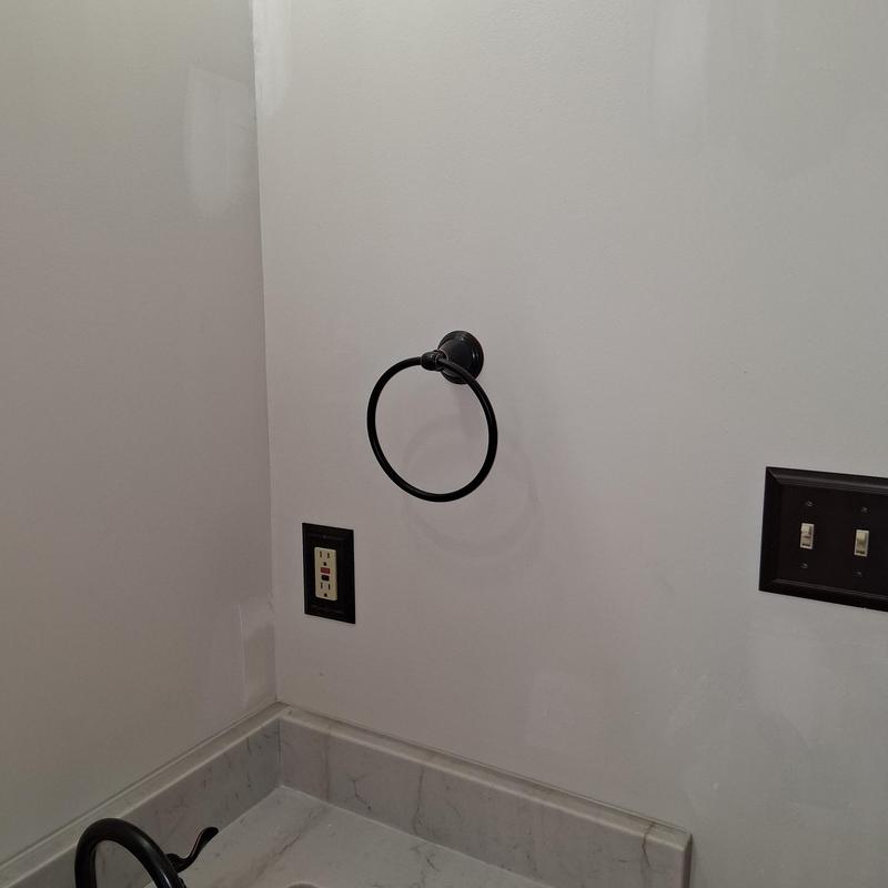 Bathroom towel ring installation on white wall