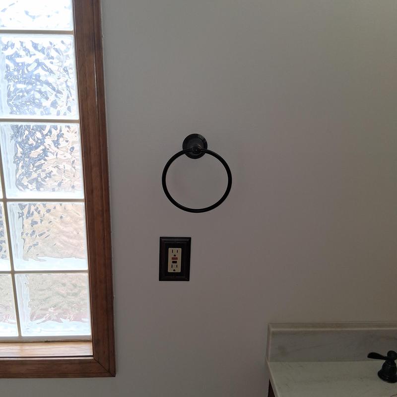 Bathroom towel ring mounted on wall by window