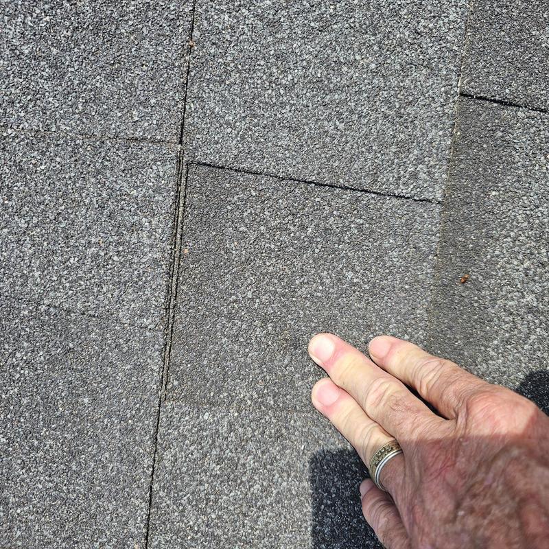Asphalt shingle roof with hail damage inspection