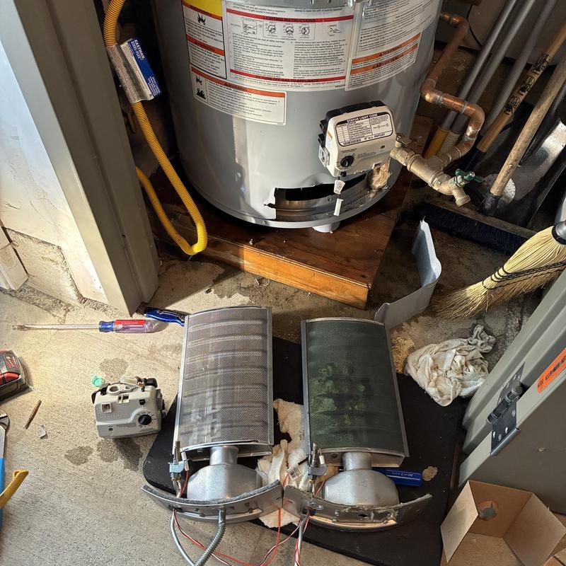 Water heater burner assemblies removed for repair