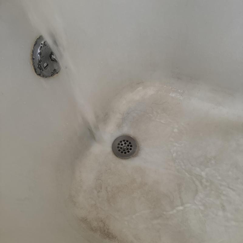 Bathtub drain with flowing water testing proper flow