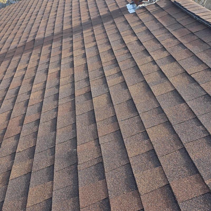 Asphalt shingle roof with hail damage and repairs