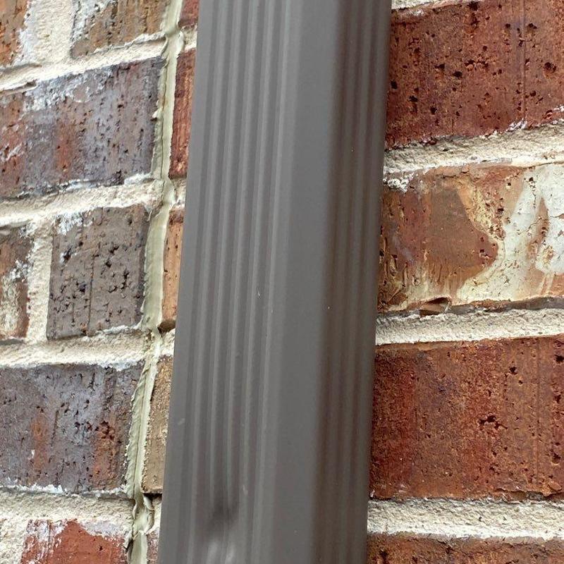 Gutter downspout close-up on brick wall Gutter downspout close-up on brick wall