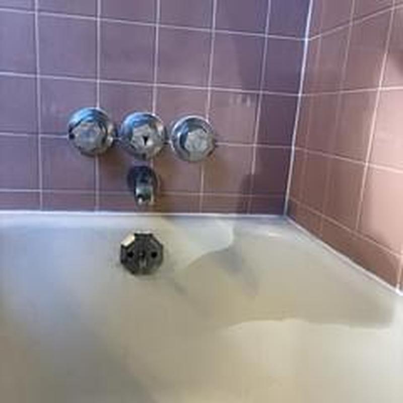 Vintage bathtub faucet with three control knobs and spout