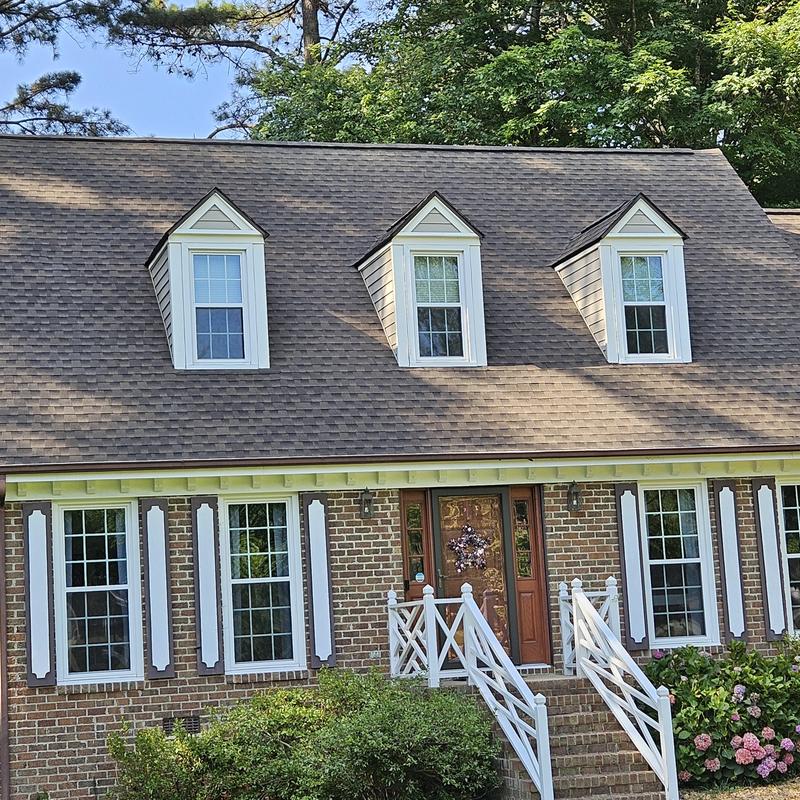 asphalt shingle roof on brick home with dormer windows
