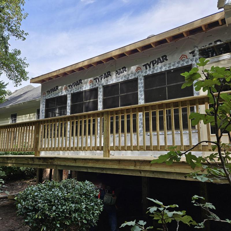 Screened porch addition with wooden deck railing Screened porch addition with wooden deck railing