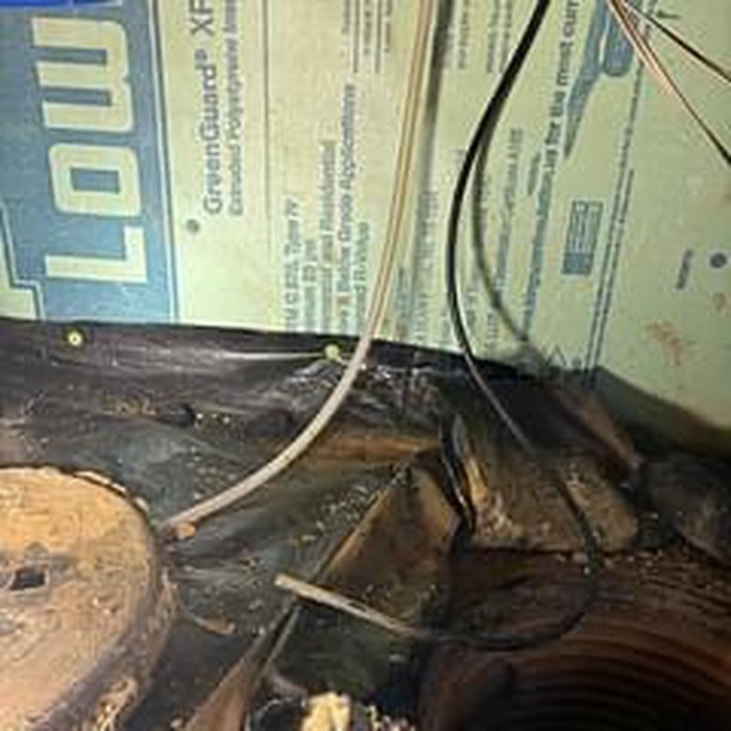 Sump pump pit with electrical wiring and insulation panels