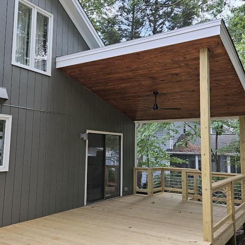 Covered patio with wood ceiling and cable railing Covered patio with wood ceiling and cable railing