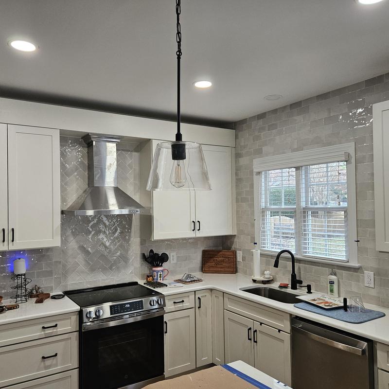 Kitchen cabinetry and trim with tile backsplash Kitchen cabinetry and trim with tile backsplash