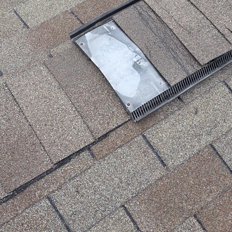 Roof shingles with hail damage near vent flashing