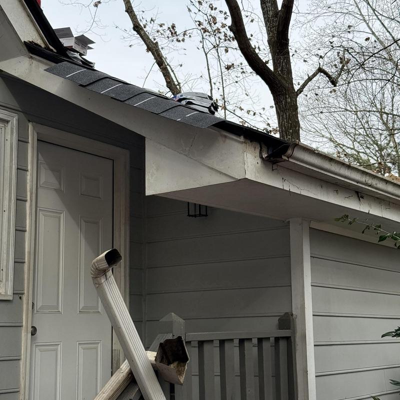 Downspout disconnected from gutter on house exterior