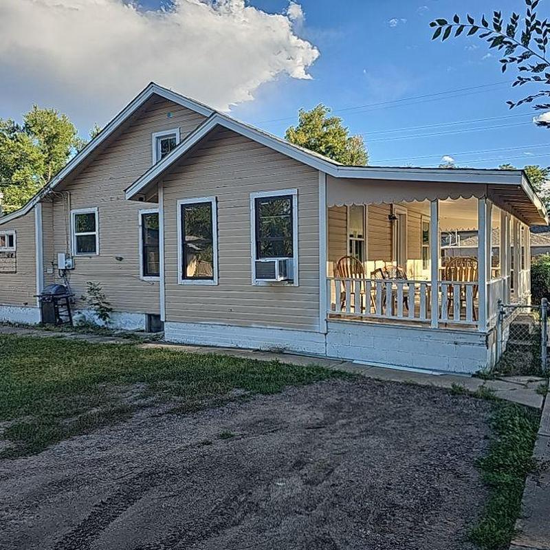 House siding with porch and windows in daylight House siding with porch and windows in daylight