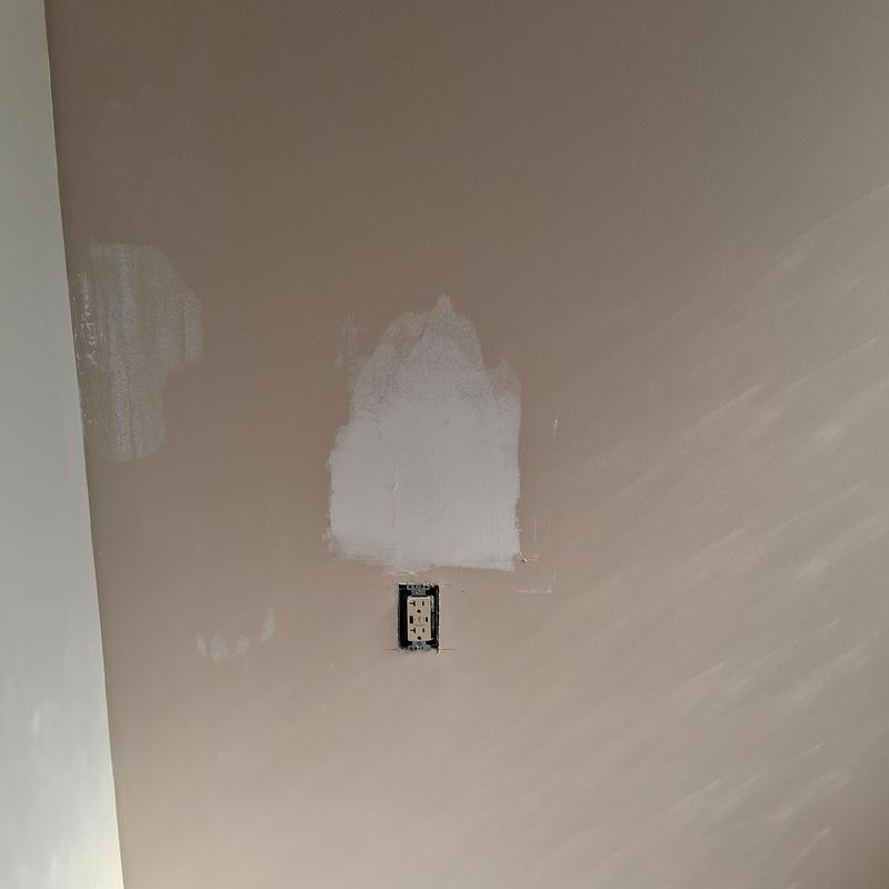 Sheetrock patch with electrical outlet in beige wall