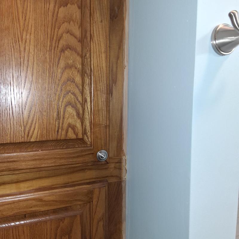 Wood cabinet trim with patched and stained corner detail