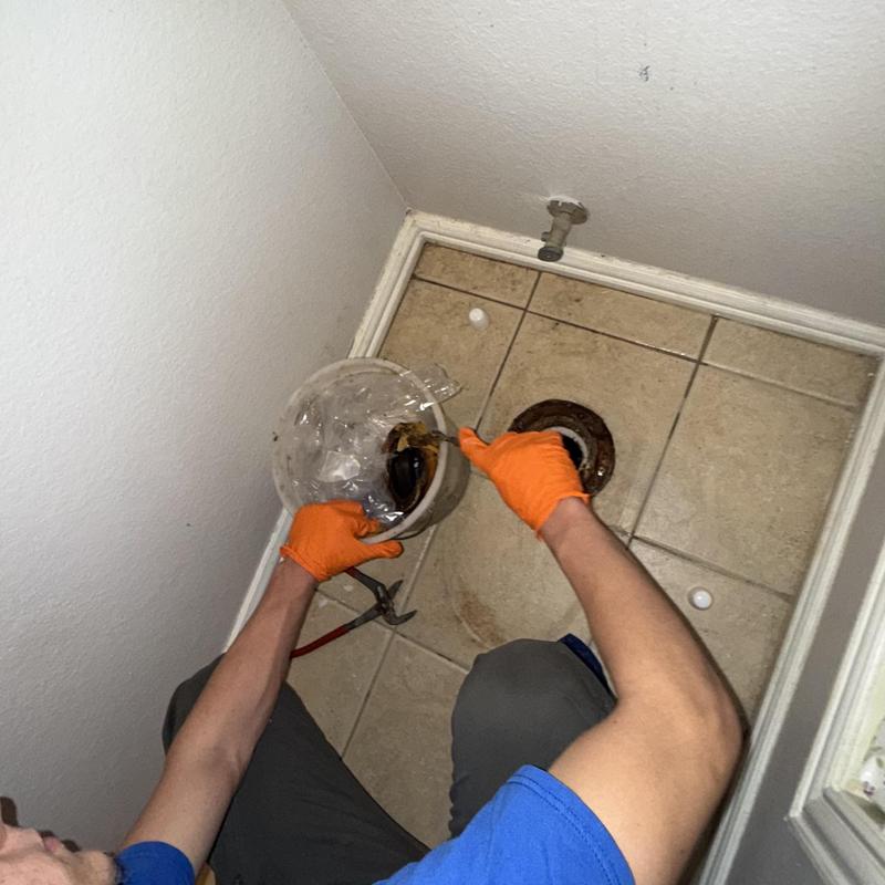 Toilet flange replacement with new wax ring on tile floor