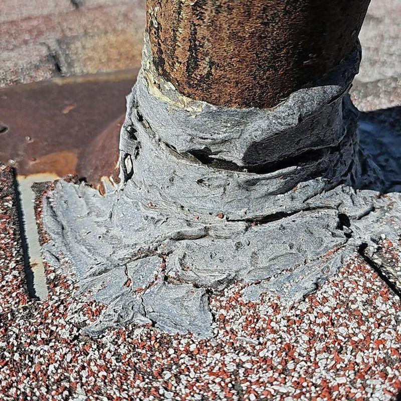 Pipe jack with cracked, aged tar roofing sealant Pipe jack with cracked, aged tar roofing sealant