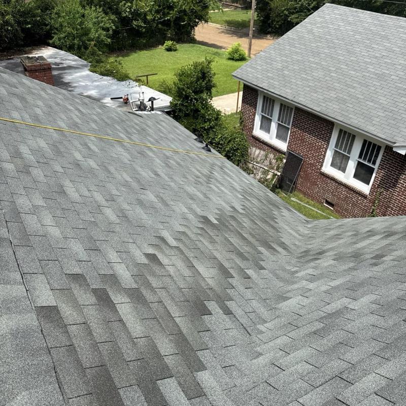 Asphalt shingle roof inspection with tape measure
