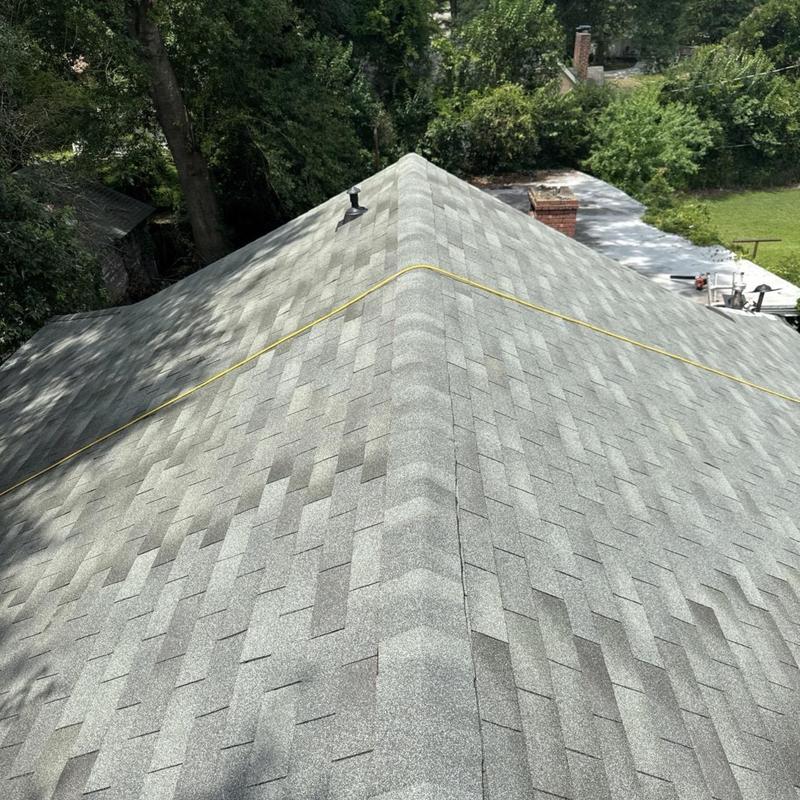 Asphalt shingle roof ridge with inspection line in Florence