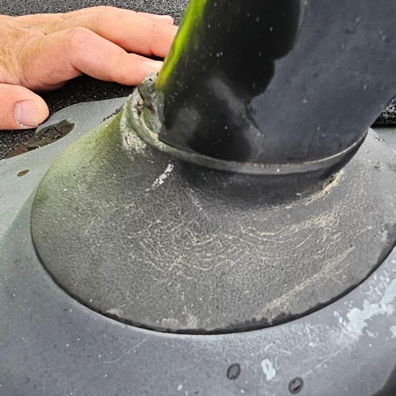 Pipe jack flashing on shingle roof with hand nearby Pipe jack flashing on shingle roof with hand nearby