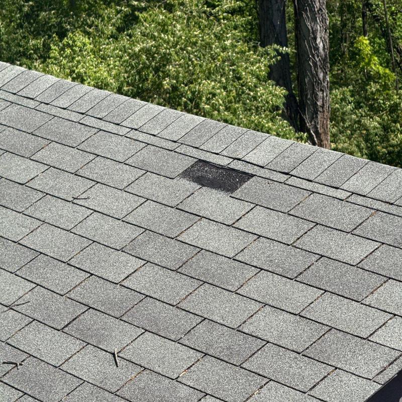 Asphalt shingle roof with hail damage spotting