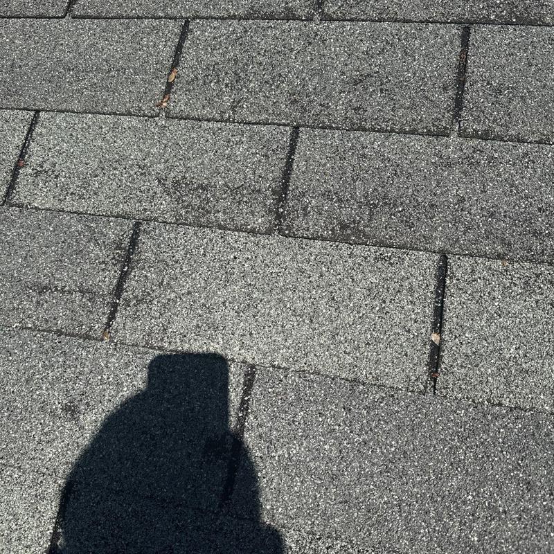 Asphalt shingle roof with visible hail damage