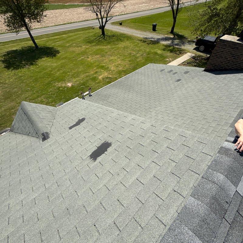 Roof shingles with hail damage and repair patches