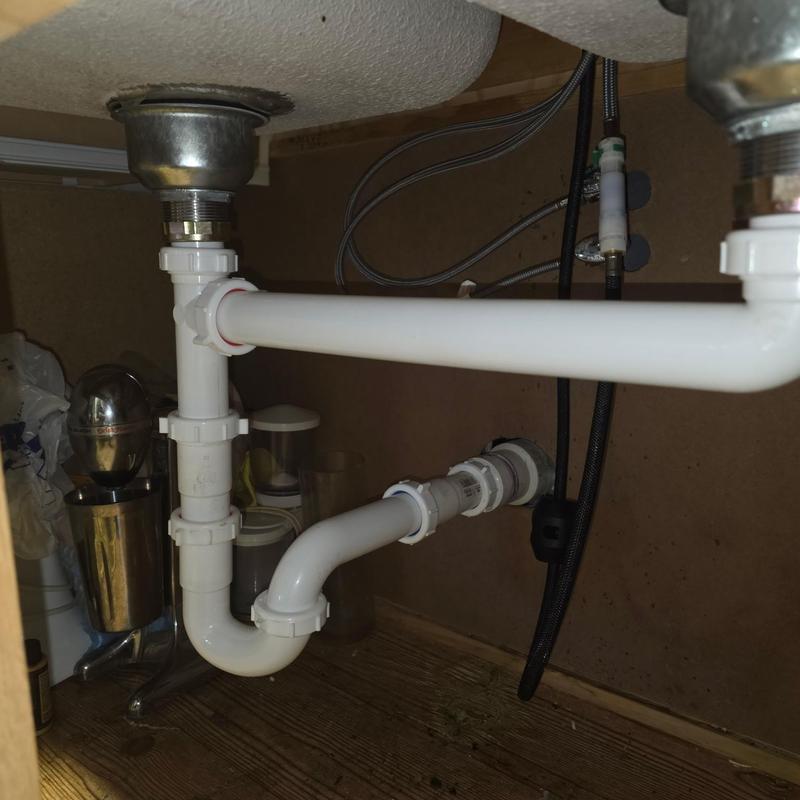 Double kitchen sink drain system with new PVC pipes installed