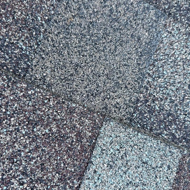 Asphalt shingles with visible hail damage close-up