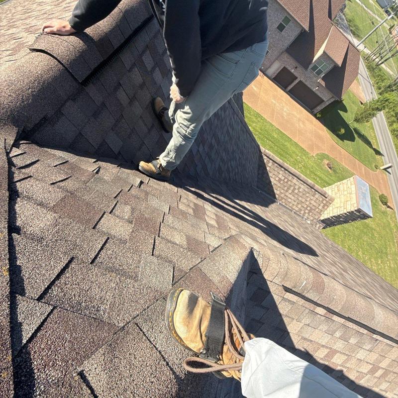 Asphalt shingle roof ridge inspection with workers