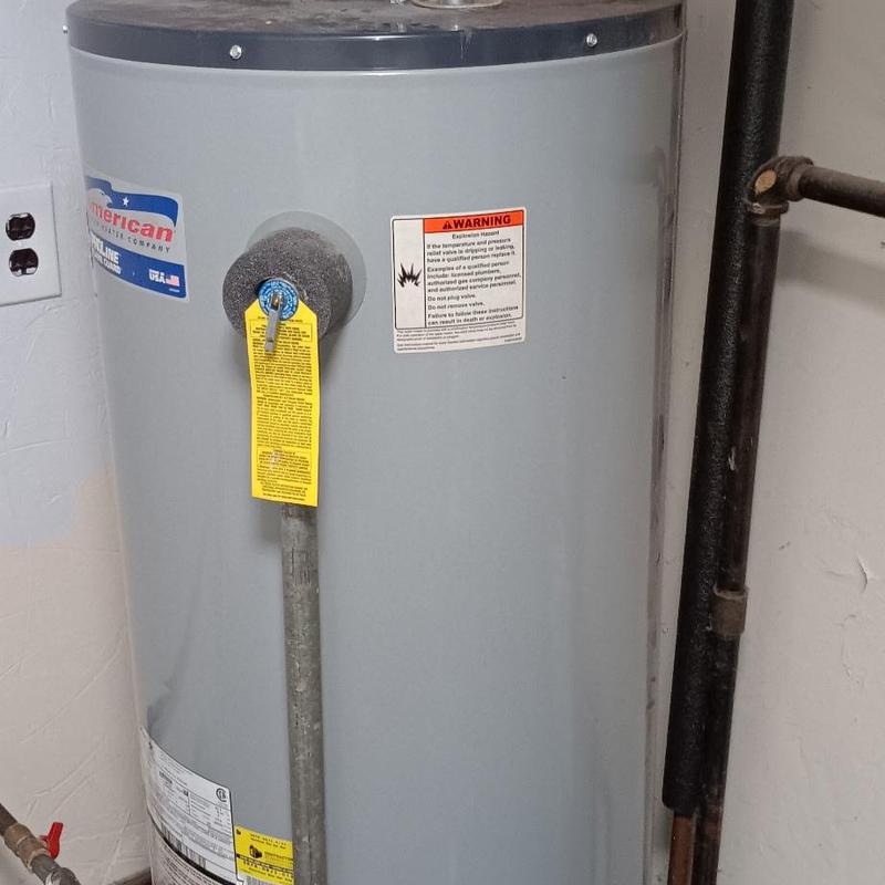 Electric water heater with safety valve and pipes
