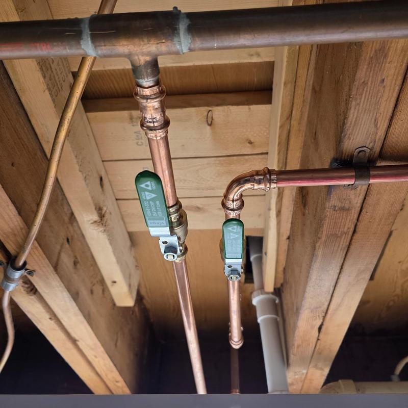 Copper piping with green ball valves installed
