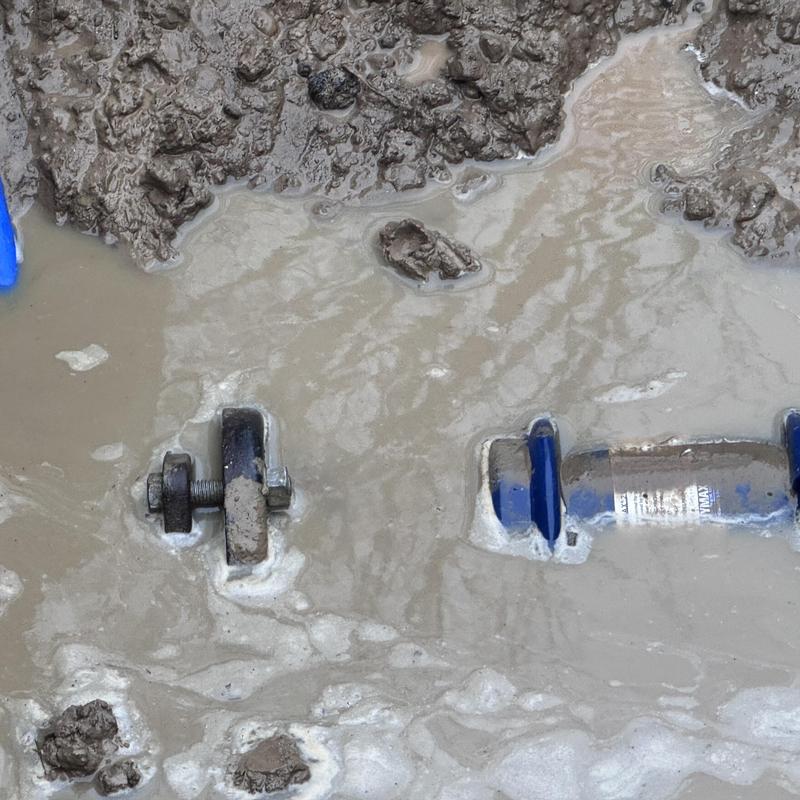 Cast iron water line with coupling in muddy trench