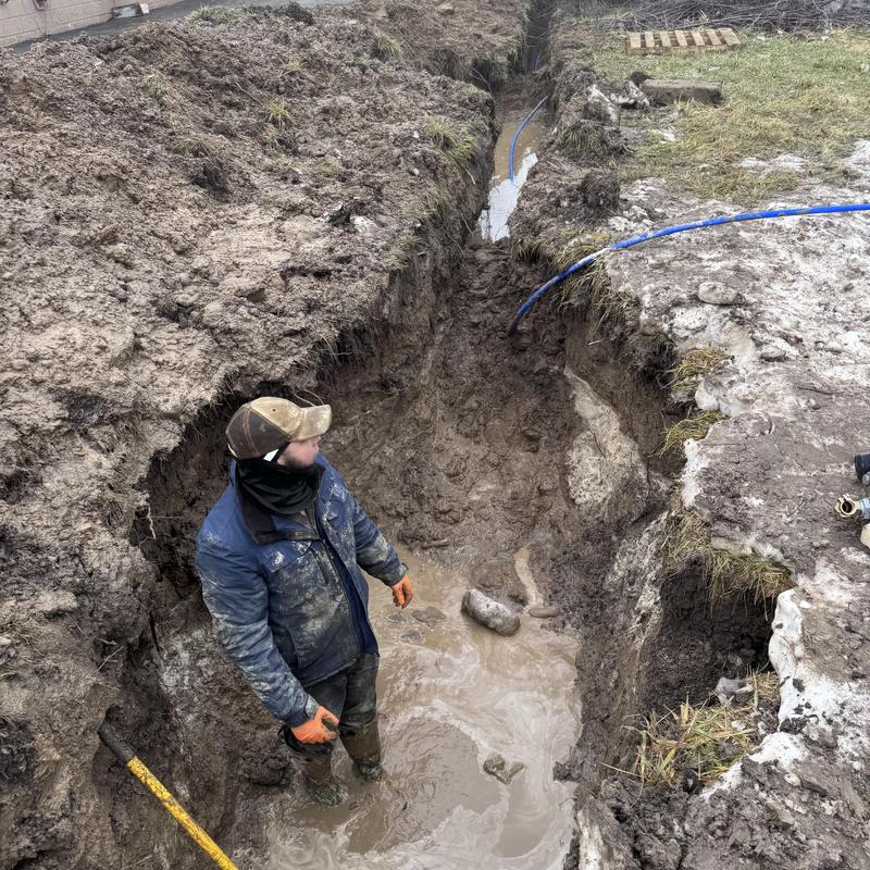 Cast iron water line trench with muddy water