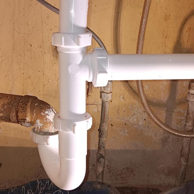 Tubular PVC drain pipe under kitchen sink