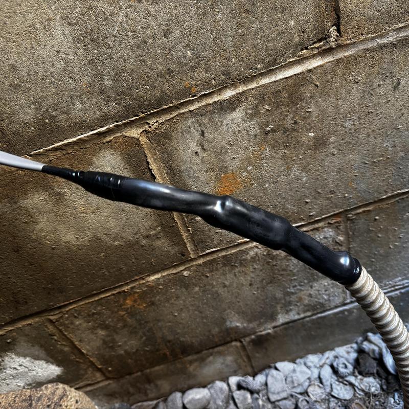 Water line pipe with insulation wrap near foundation wall