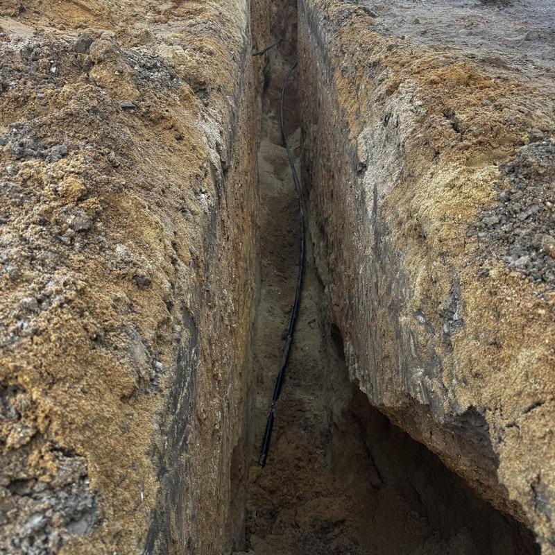 Water line trench with new poly pipe installation