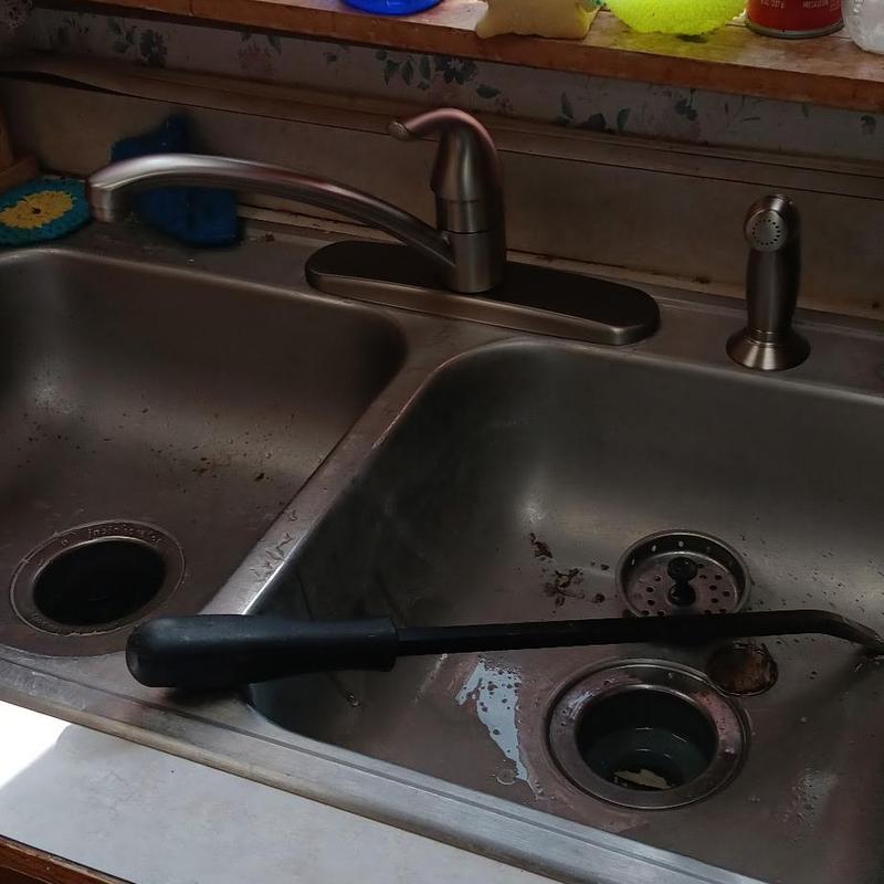 Kitchen sink drain with plumbing snake tool inside
