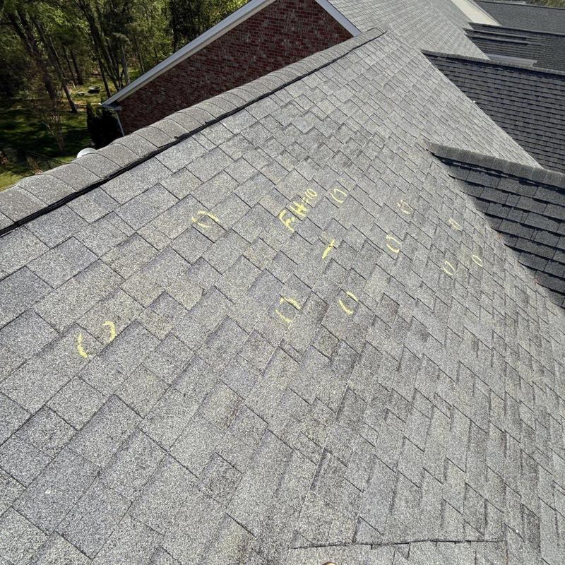 Asphalt shingle roof with hail damage markings