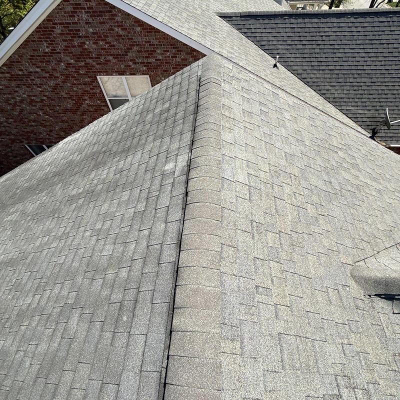 Asphalt shingle roof ridge cap with hail damage inspection