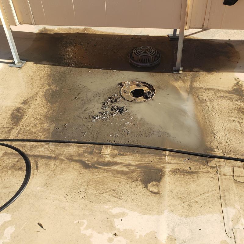 TPO flat roof drain area with debris and damage TPO flat roof drain area with debris and damage