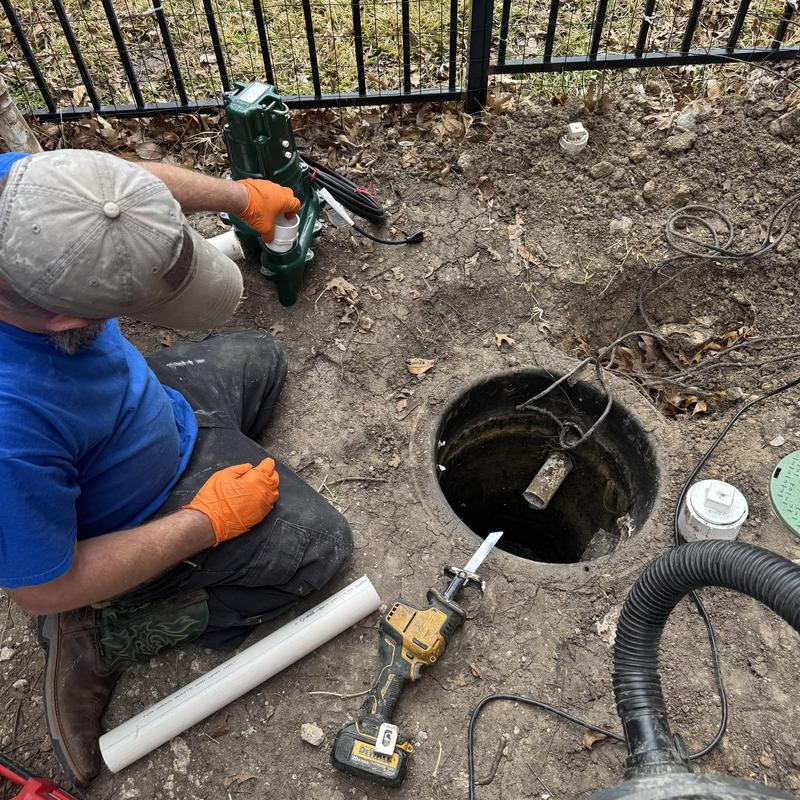 Grinder pump installation next to outdoor sump pit