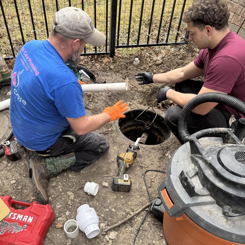 Grinder pump replacement with plumbing tools outdoors